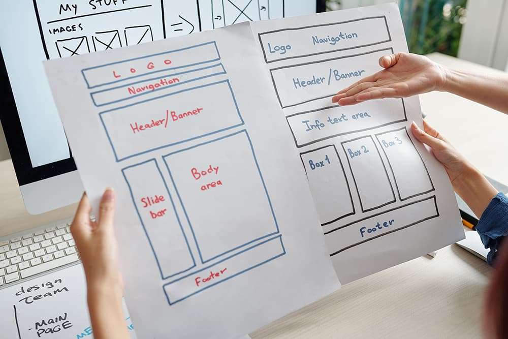 10 Reasons to Update Your Website 4 Designers discussing website layouts